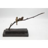 Stylised bronze character group of three birds on a branch upon a marble base, H 19cm x W 32cm