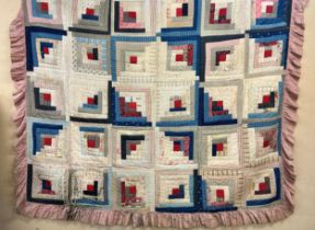 Victorian quilted bed cover with log cabin style cotton printed panels having a later pink frilled