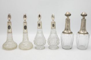 Three pairs of continental silver applied decanters or small scent bottles, the largest 20cm high (