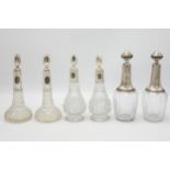 Three pairs of continental silver applied decanters or small scent bottles, the largest 20cm high (