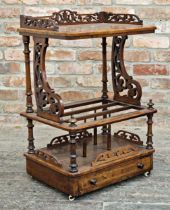 Victorian walnut Canterbury whatnot with fret carved lyre sides and drawer to base, raised on