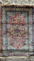 Good quality small silk prayer mat or rug, central medallion on pink ground, long fringe, 92 x