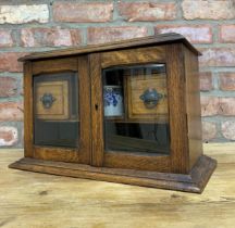 Edwardian oak wood smokers cabinet with bevelled glass doors, original metal ashtray and ceramic