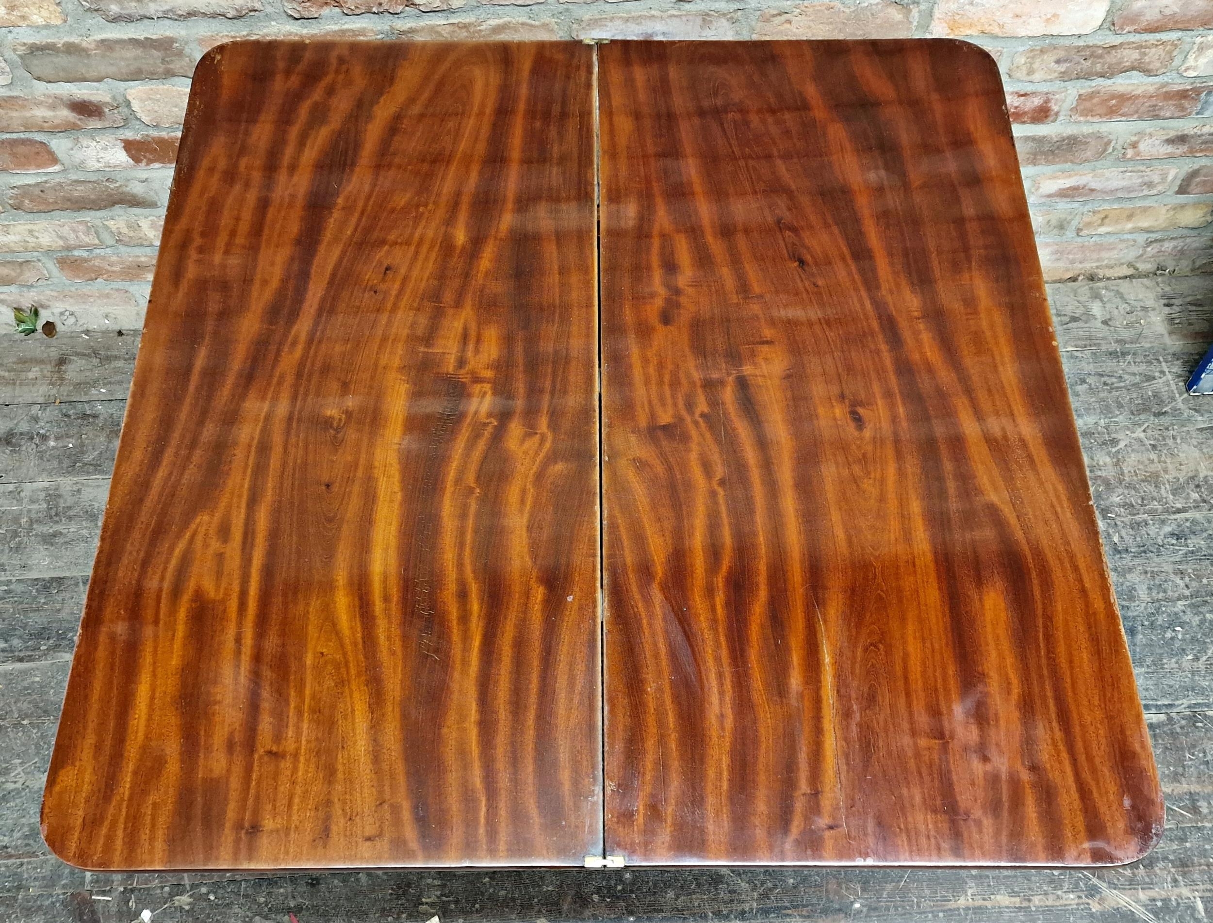 Regency mahogany fold over top card table, raised on a quadruped base with sabre supports on brass - Image 3 of 4