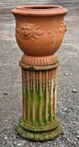 French terracotta urn with lions mask detail raised on a fluted terracotta pedestal, H 82cm x DIA