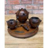 Hand carved mahogany sea mine desk tidy to include match strike, inkwell, lidded storage and