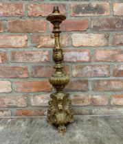 Carved gilt pricket stick lamp base with lion paw feet and cherub face decoration, H 62cm