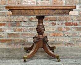 Regency mahogany fold over top card table, raised on a quadruped base with sabre supports on brass