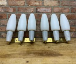Two sets of brass Mid-Century three branch wall lights having period milk glass shades, H 40cm x W