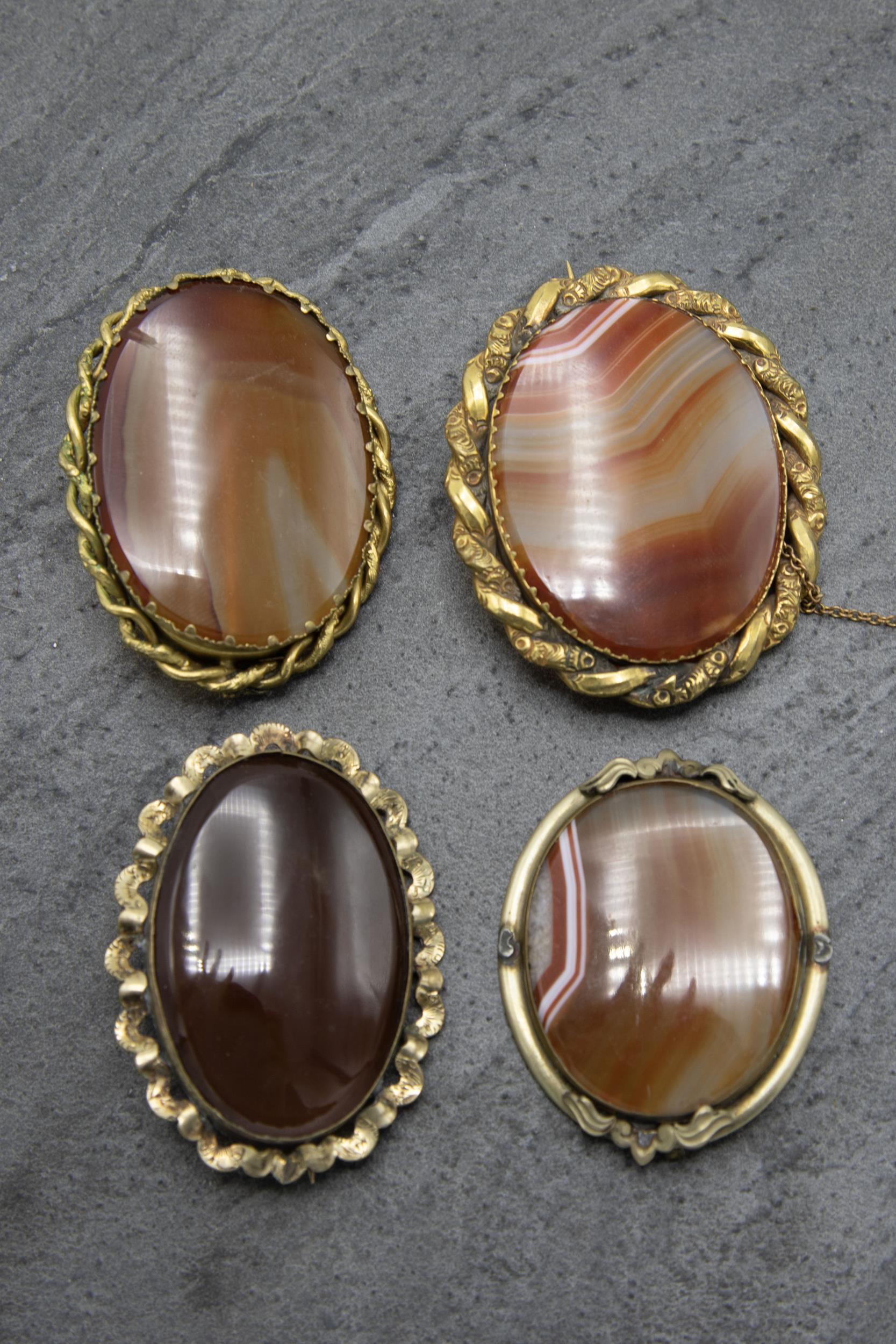 Four large 19th century carnelian and pinchbeck brooches, the largest 5 x 6cm (4)