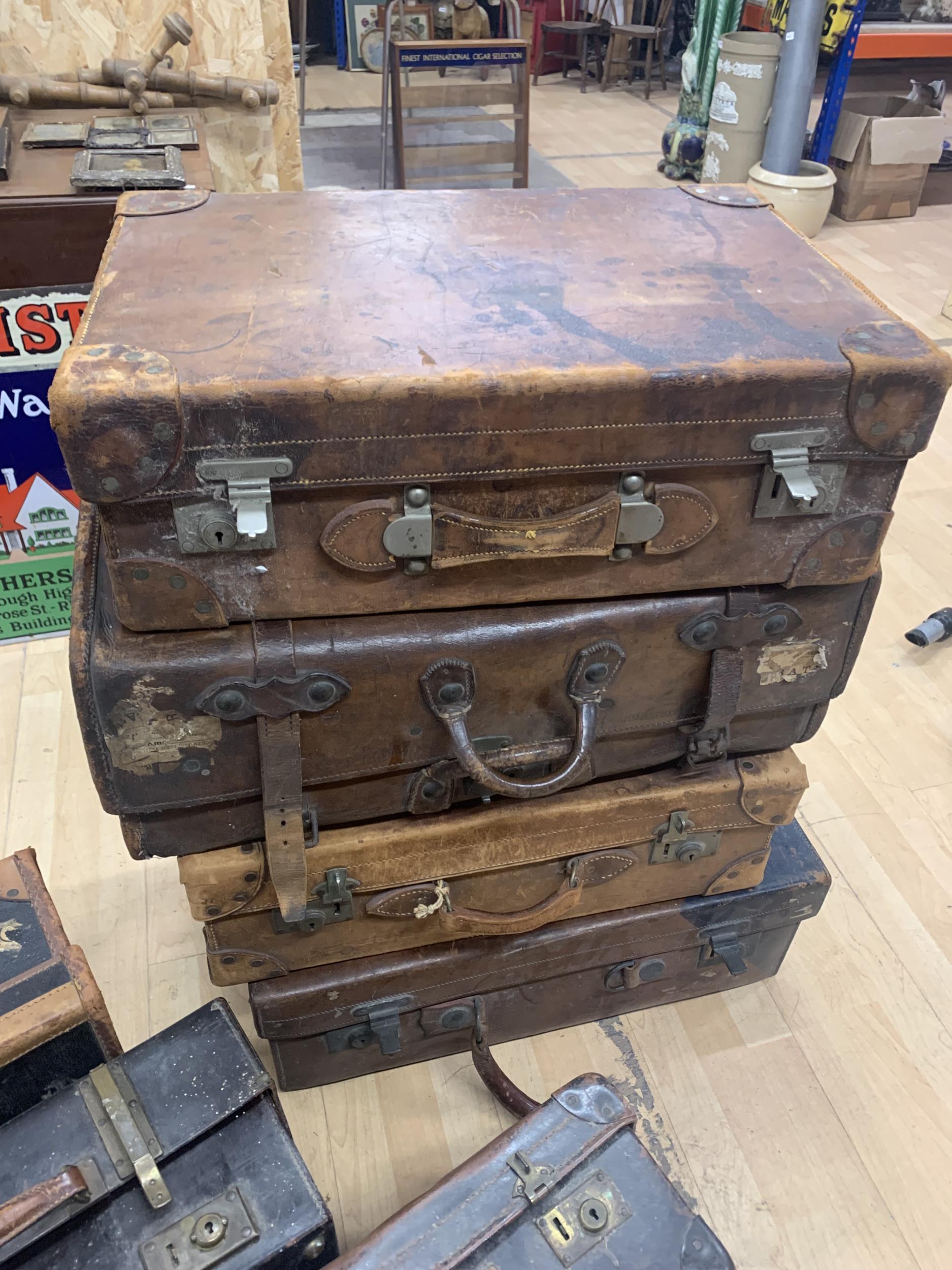 Collection of eight antique brown leather travel suitcases (8)