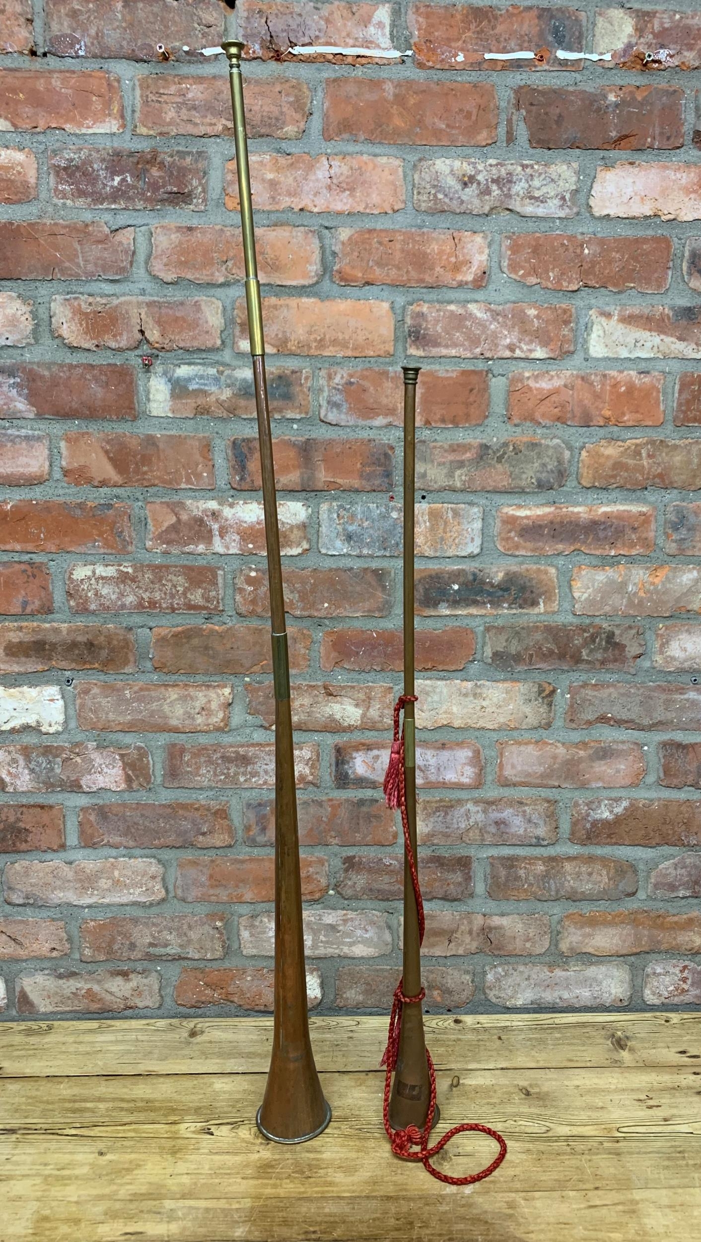 Two large copper and brass hunting horns, Largest L 130cm (2)