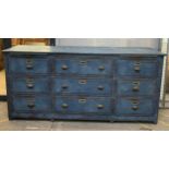 Substantial antique painted industrial sideboard or bank of drawers, fitted with nine deed fielded