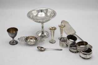 Mixed silver comprising tazza, five napkin rings, two small vases, strainer, egg cup, 800 fish slice