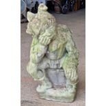 A weathered reconstituted stone garden statue of a jester, H 70cm