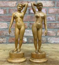 Pair of well carved lime wood nude female sculptures, H 34cm