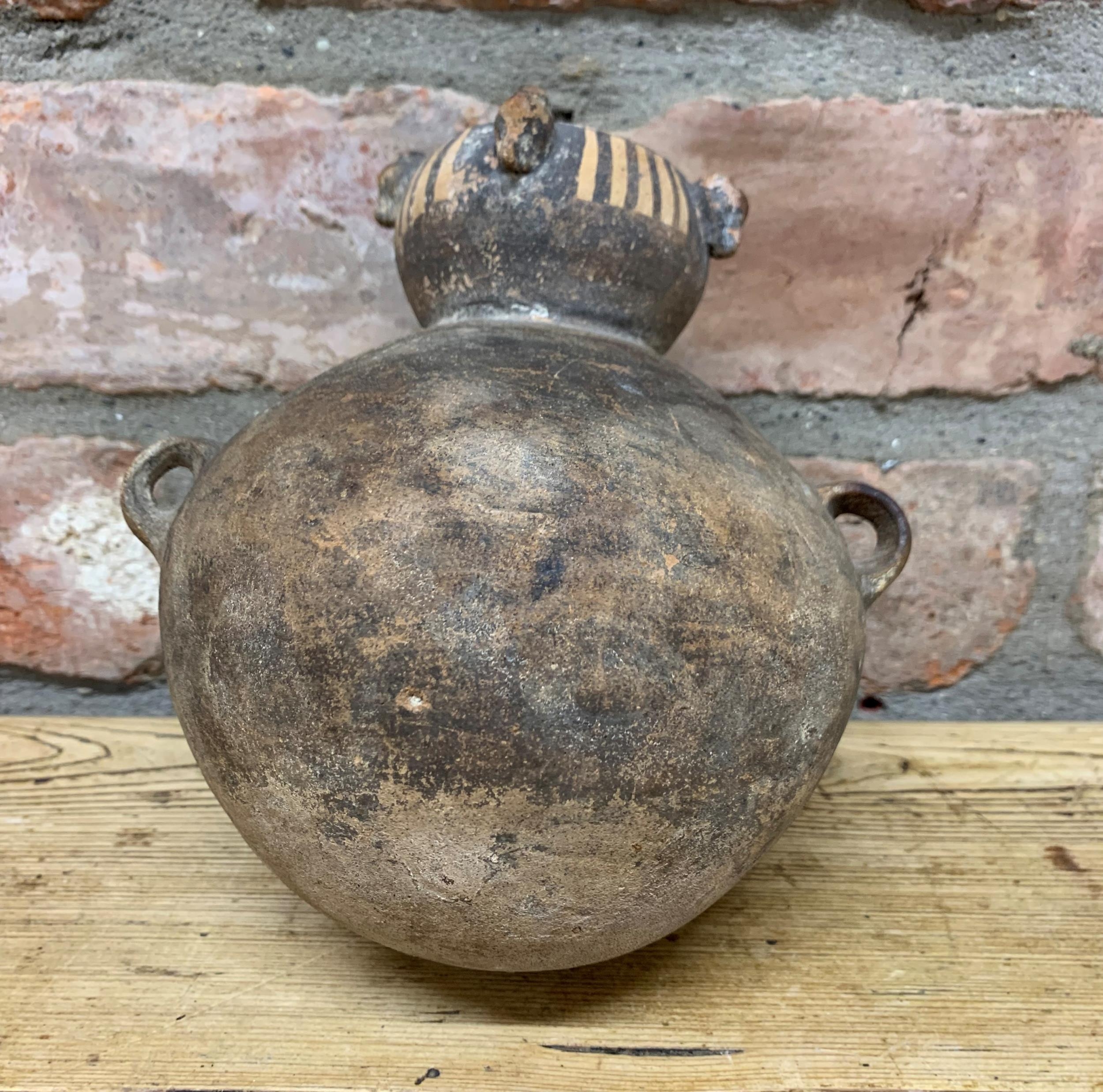 Archaic Incan double handed terracotta pot with rounded bottom and finial finish to rim, H 16cm