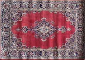 Traditional Persian Kashan rug, central blue medallion on red ground, 220 x 130cm