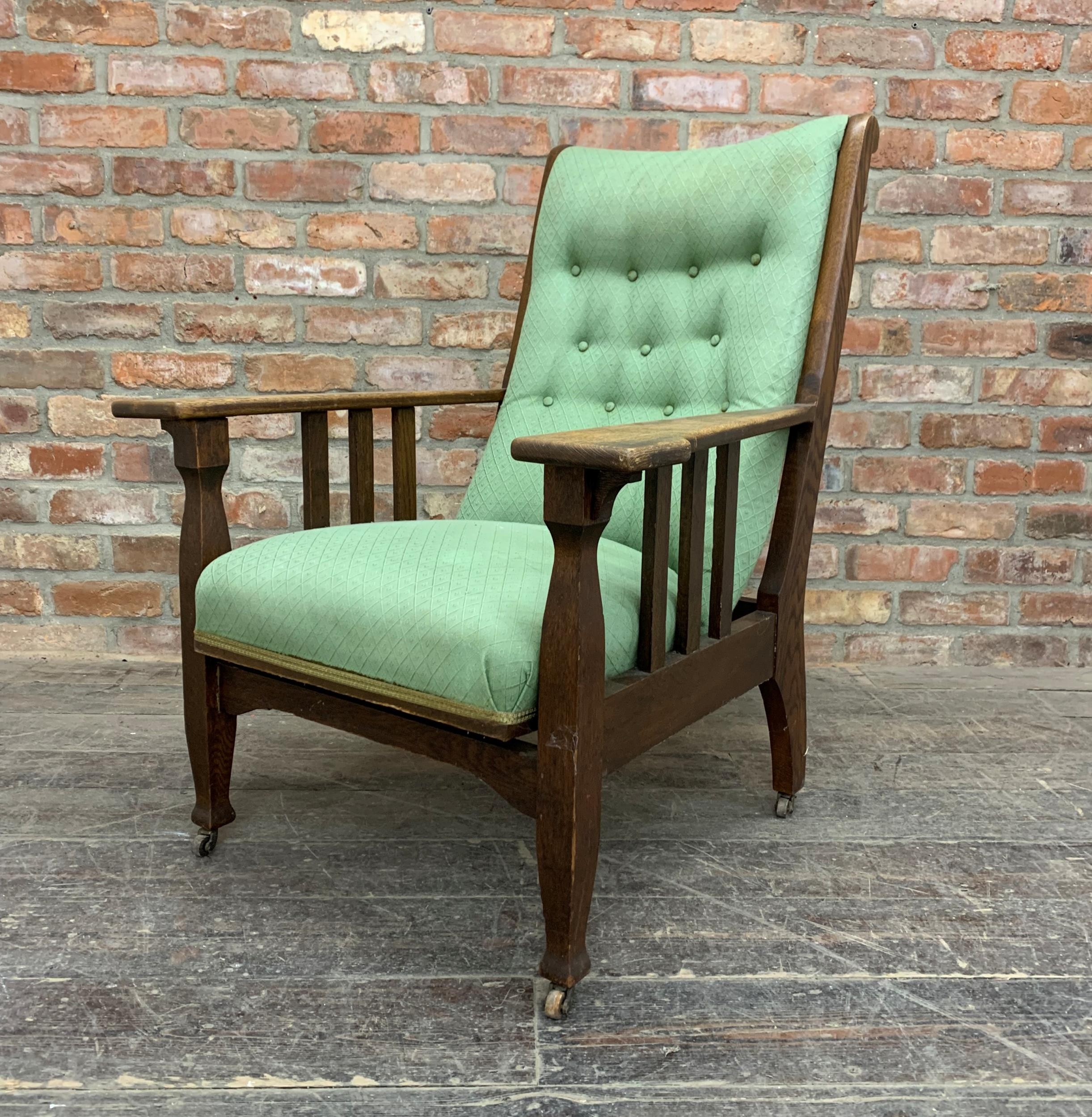 James Shoolbred Arts and Crafts oak reclining arm chair with green button back upholstery, raised