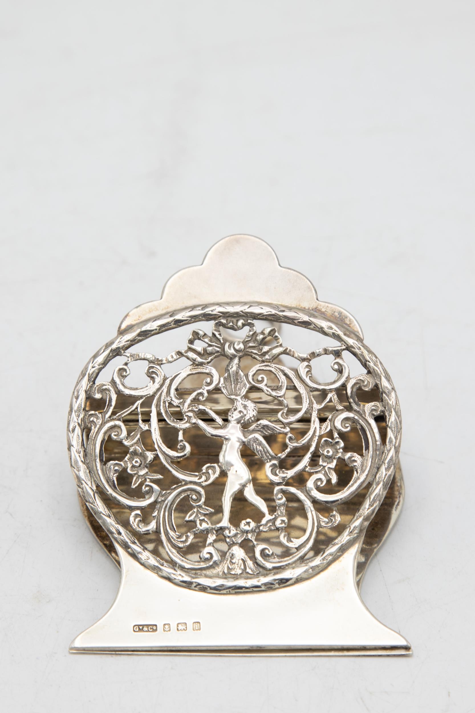 Edwardian novelty silver paperclip, pierced with a cherub and scrolled foliage, maker Grey & Co,