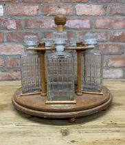Five cut glass decanters atop rotating wooden stand, H 37cm x D 35cm