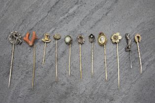 Eleven stickpins to include gold examples