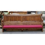 A pitch pine church pew with cushion, H 93cm x W 196cm