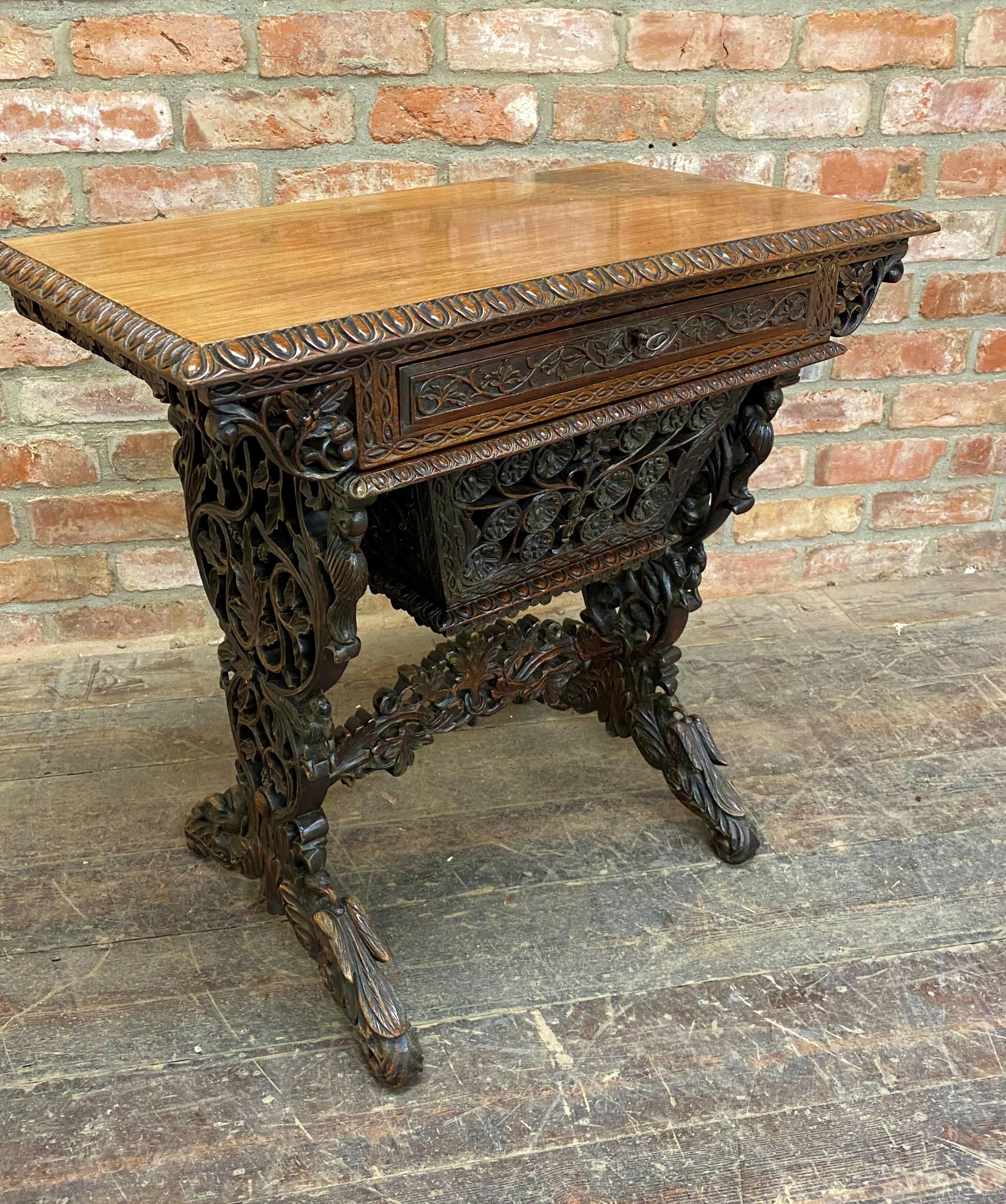 Exceptional quality Anglo Burmese / Indian padauk work table, the top with darted borders upon a