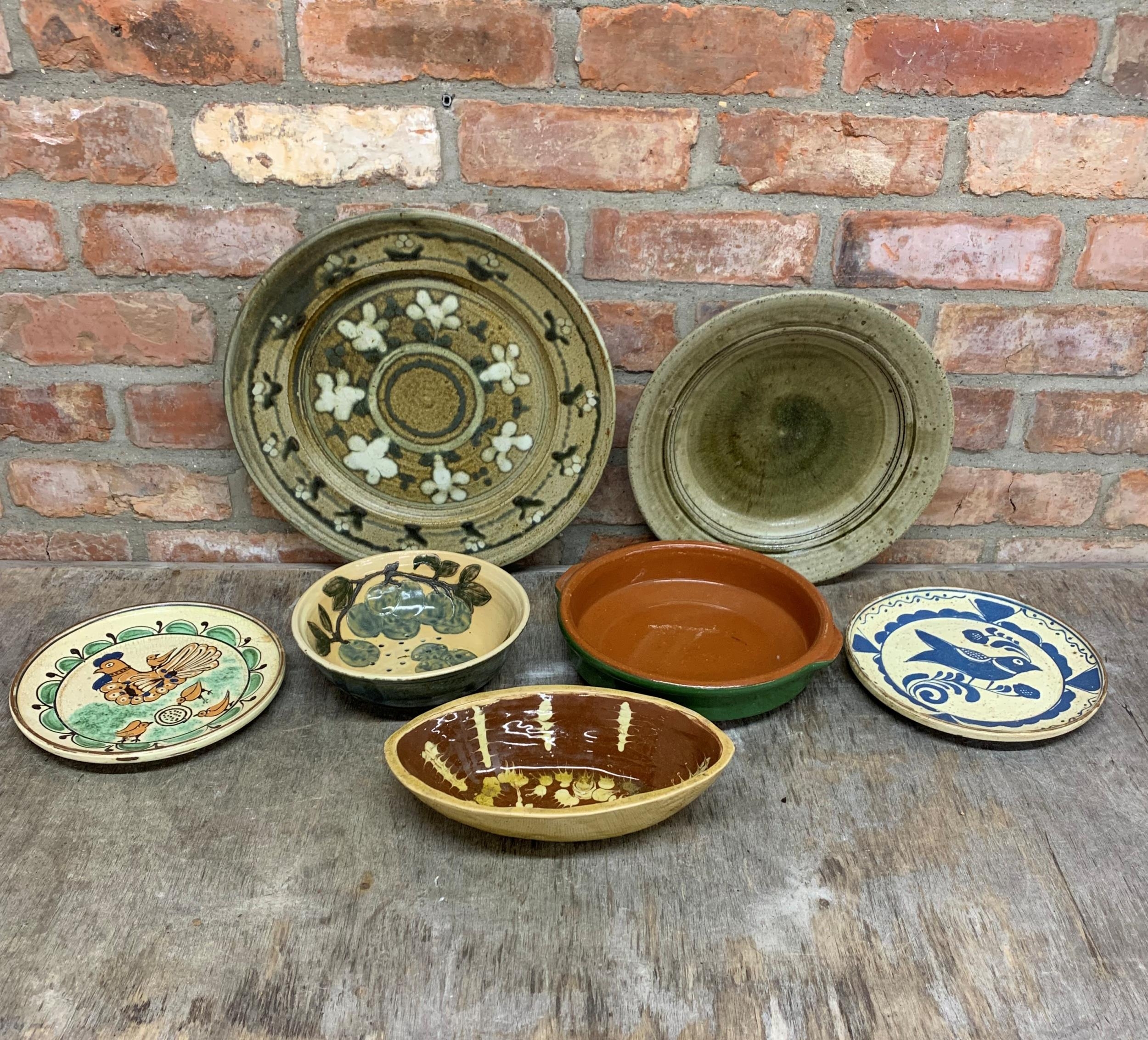 Assortment Of glazed slipware dishes to include impressive charger example, Largest D 40cm (7)