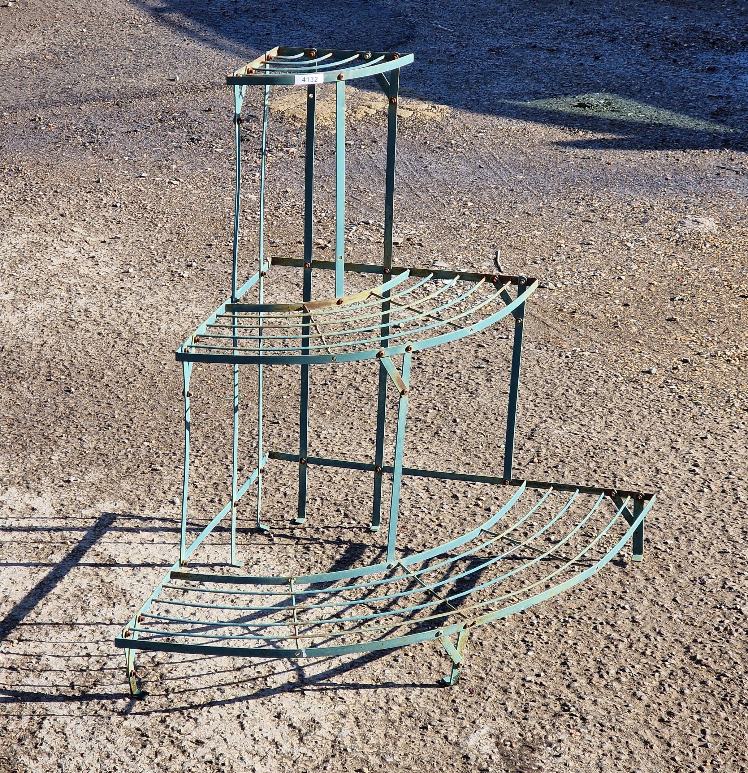 A painted metal demi-lune three tier plant stand, H 75cm