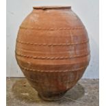 A large terracotta amphora with pressed banding and incised detail, H 70cm