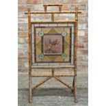 Victorian Aesthetic Movement stained glass bamboo fire screen, central painted panel depicting a