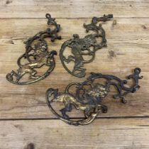 Three good quality antique gilt cast iron scrolled lion brackets, 25 x 12.5cm (3)