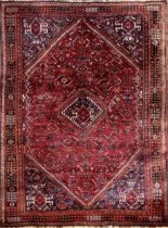 Impressive intricate hand stitched Persian carpet, tight medallion design on a deep red ground,