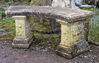 Weathered reconstituted stone three piece garden bench with curved moulded top raised on stepped