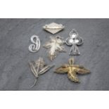 Six filigree silver brooches or pendants to include turquoise inset club pendant and enamelled