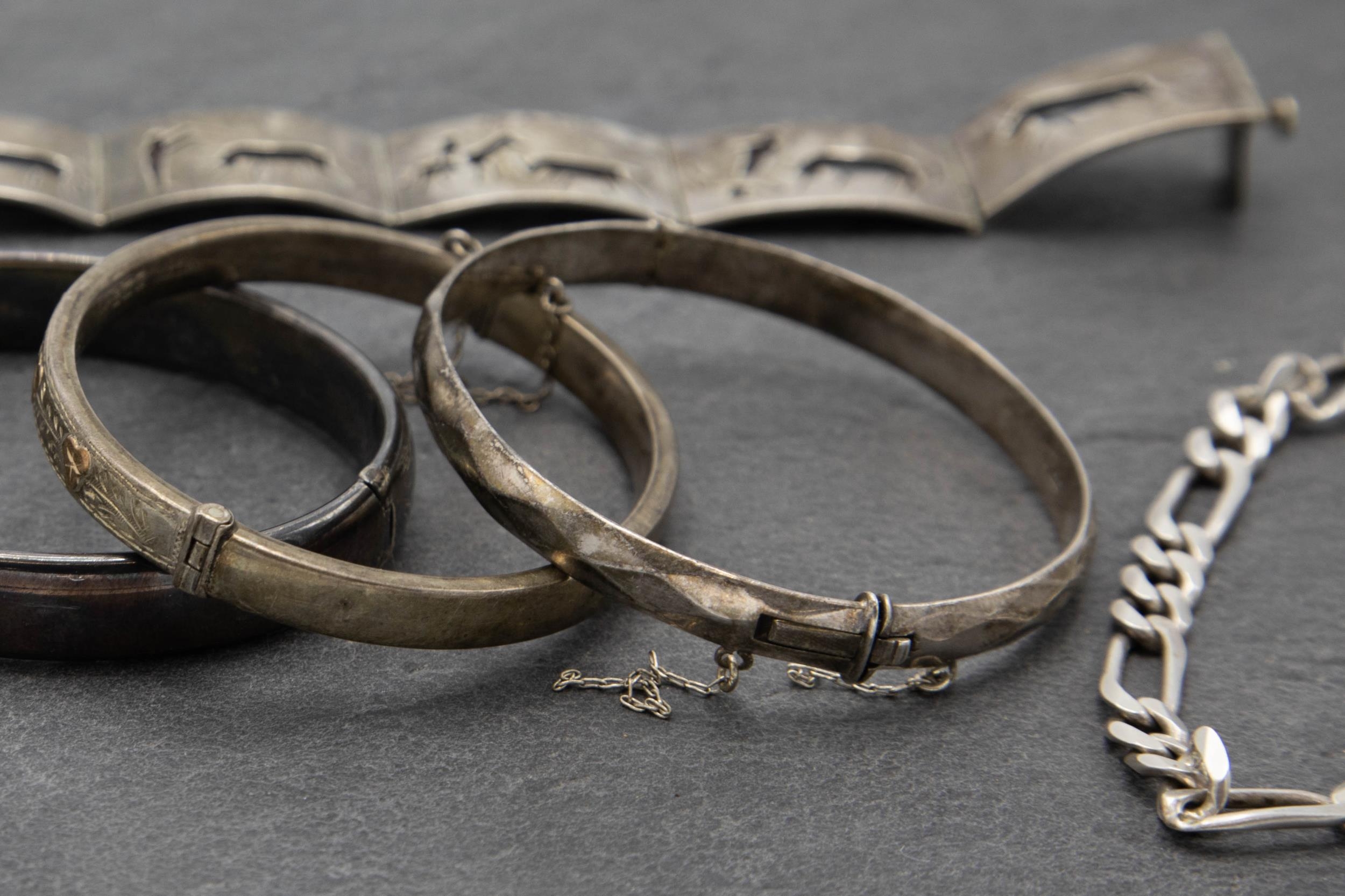 Three antique silver hinged bangles with a further Spanish silver bracelet with enamel hinged panels - Image 3 of 3