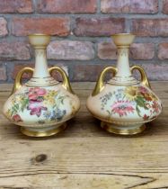 Pair of Royal Worcester hand painted blush ivory twin handled vases with floral finish throughout,