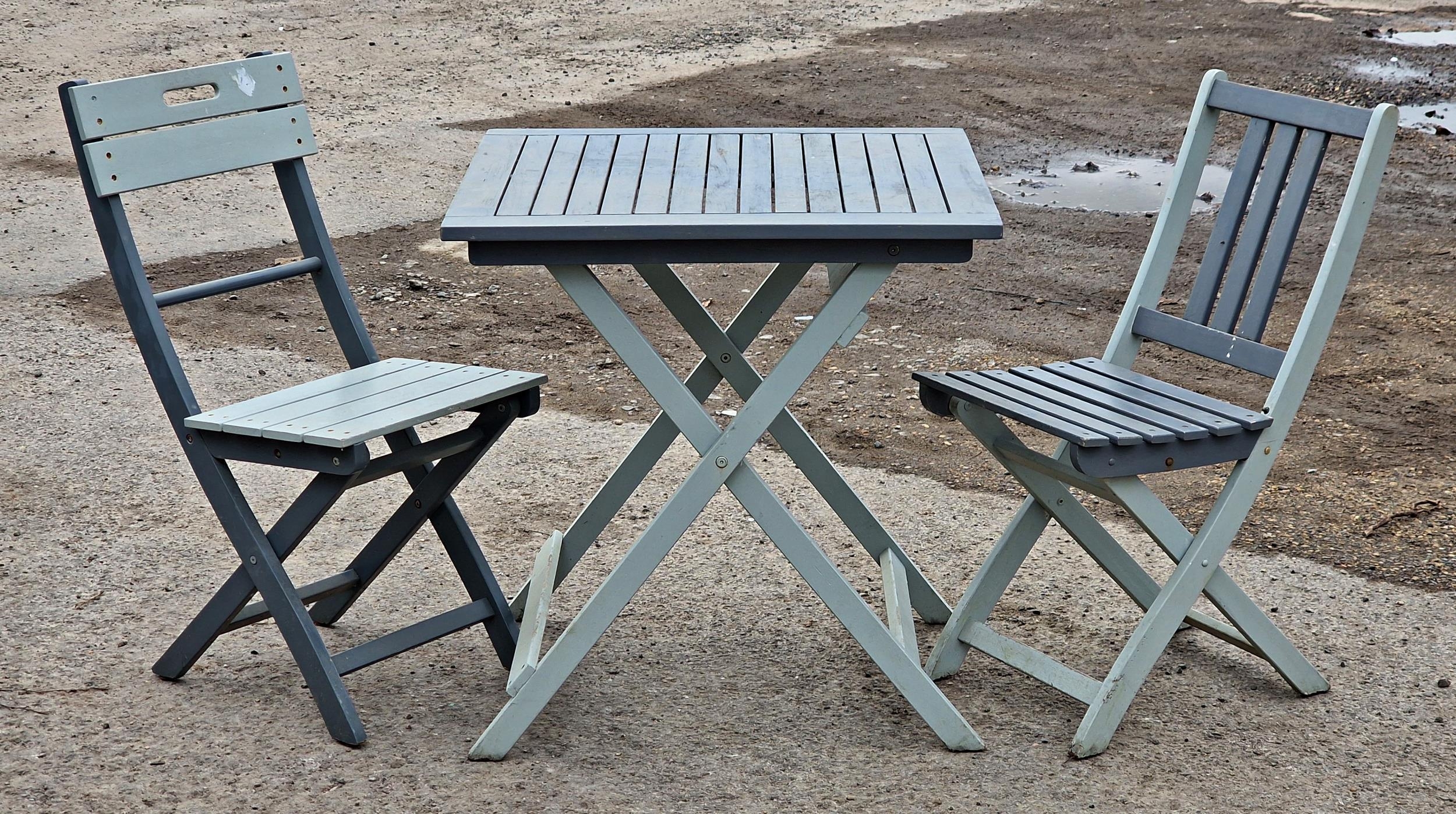 Contemporary painted wooden fold out garden table and two similar chairs, H 73cm x W 70cm x D