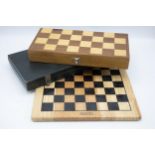 Vintage travel chess set within a folding games board and a further vintage chess set with board