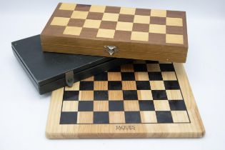 Vintage travel chess set within a folding games board and a further vintage chess set with board