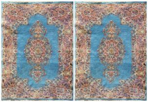 Pair of Chinese full pile wool rugs, pink medallions on sky blue ground, 210 x 125cm (2)