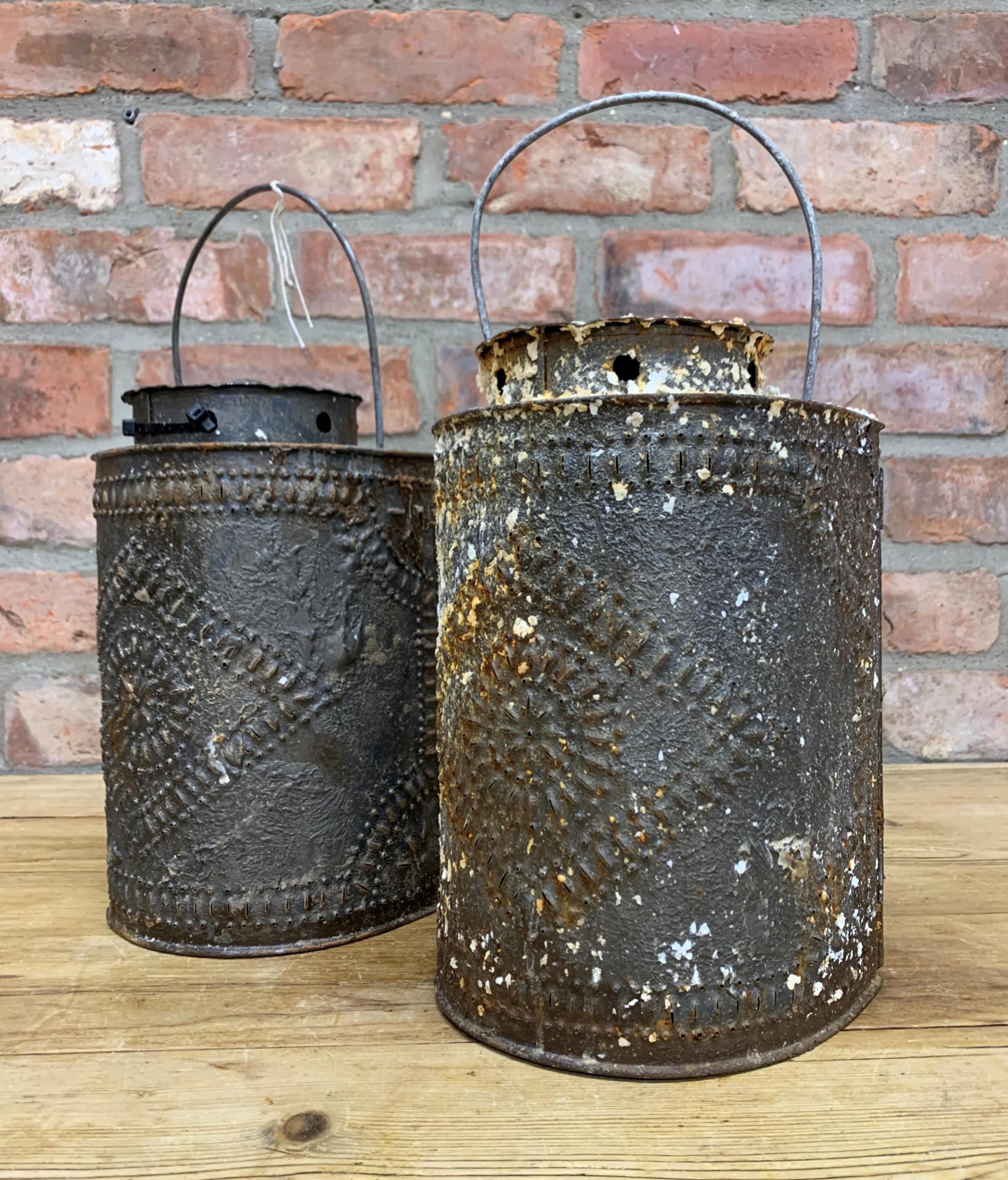 Pair of Indian tin storm lanterns, beaten with floral decoration, 27cm high (2)