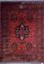 Good quality Afghan rug, five black medallions on a deep red ground, 210 x 130cm