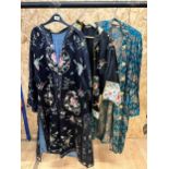 Vintage black ground Oriental robe with embordered floral and inset detail together with a further