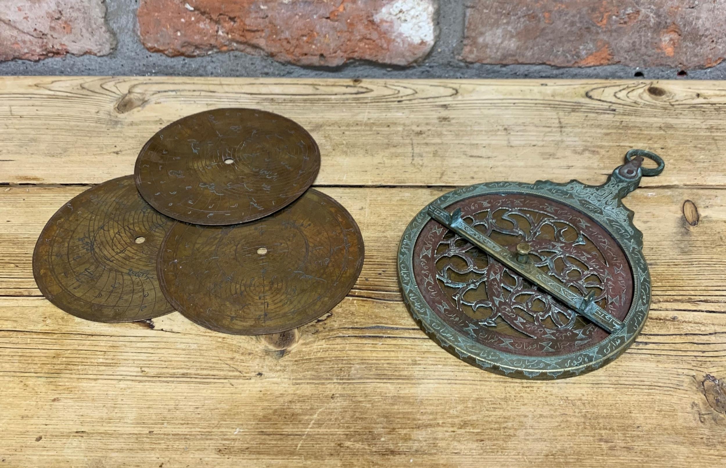 Large Antique Islamic brass astrolabe instrument, engraved throughout having pierced rete, four