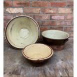 Three graduated glaze terracotta dairy bowls, the largest H 19cm x D 42cm