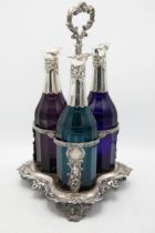 Exceptional quality Victorian three bottle cruet and stand, three faceted coloured glass bottles