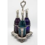Exceptional quality Victorian three bottle cruet and stand, three faceted coloured glass bottles
