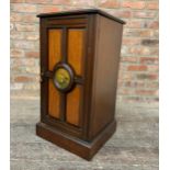 A Victorian mahogany and satinwood pot cupboard with circular painted panel depicting a nesting